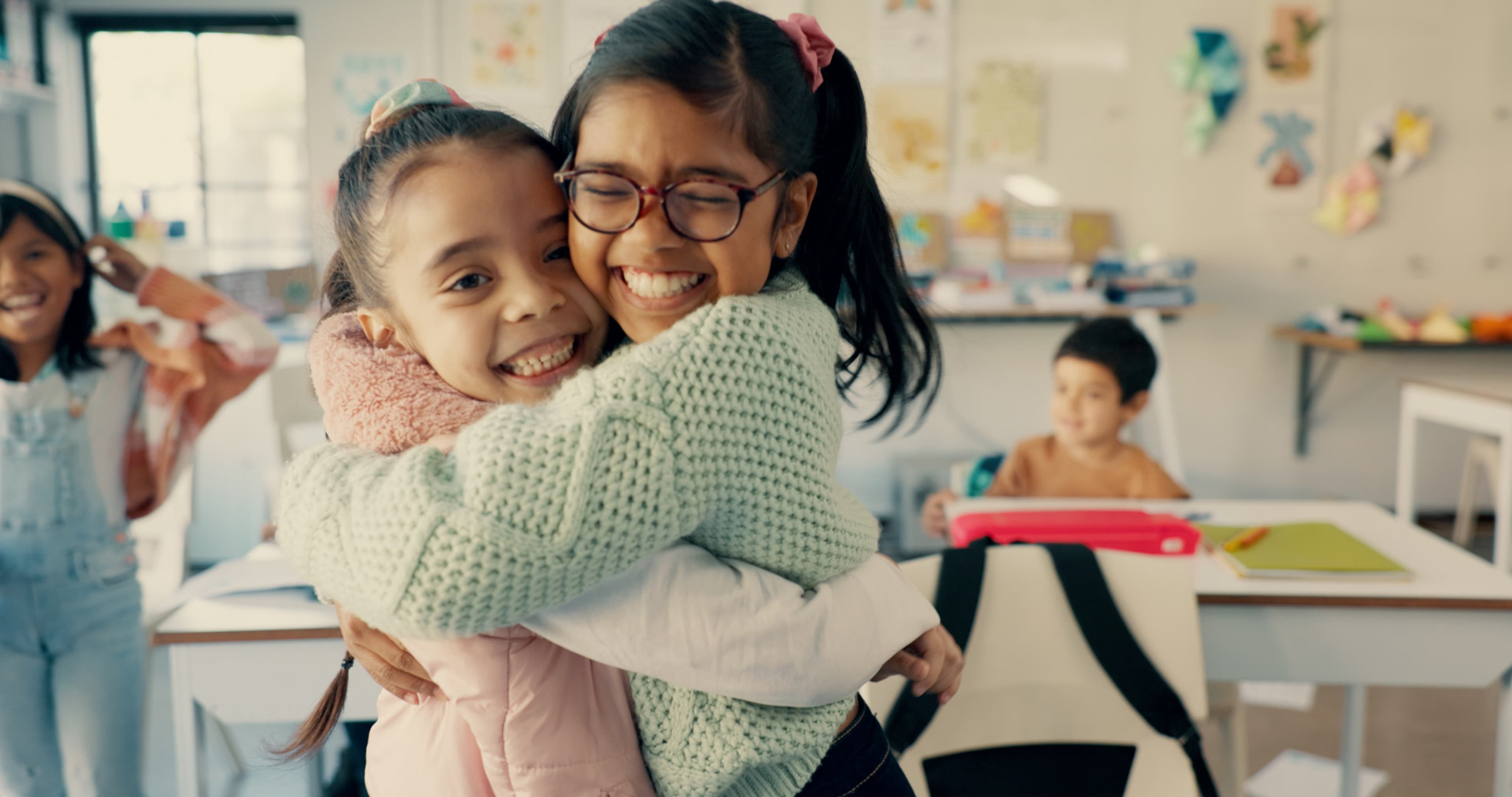A teacher sharing a happy moment with a child in the classroom
