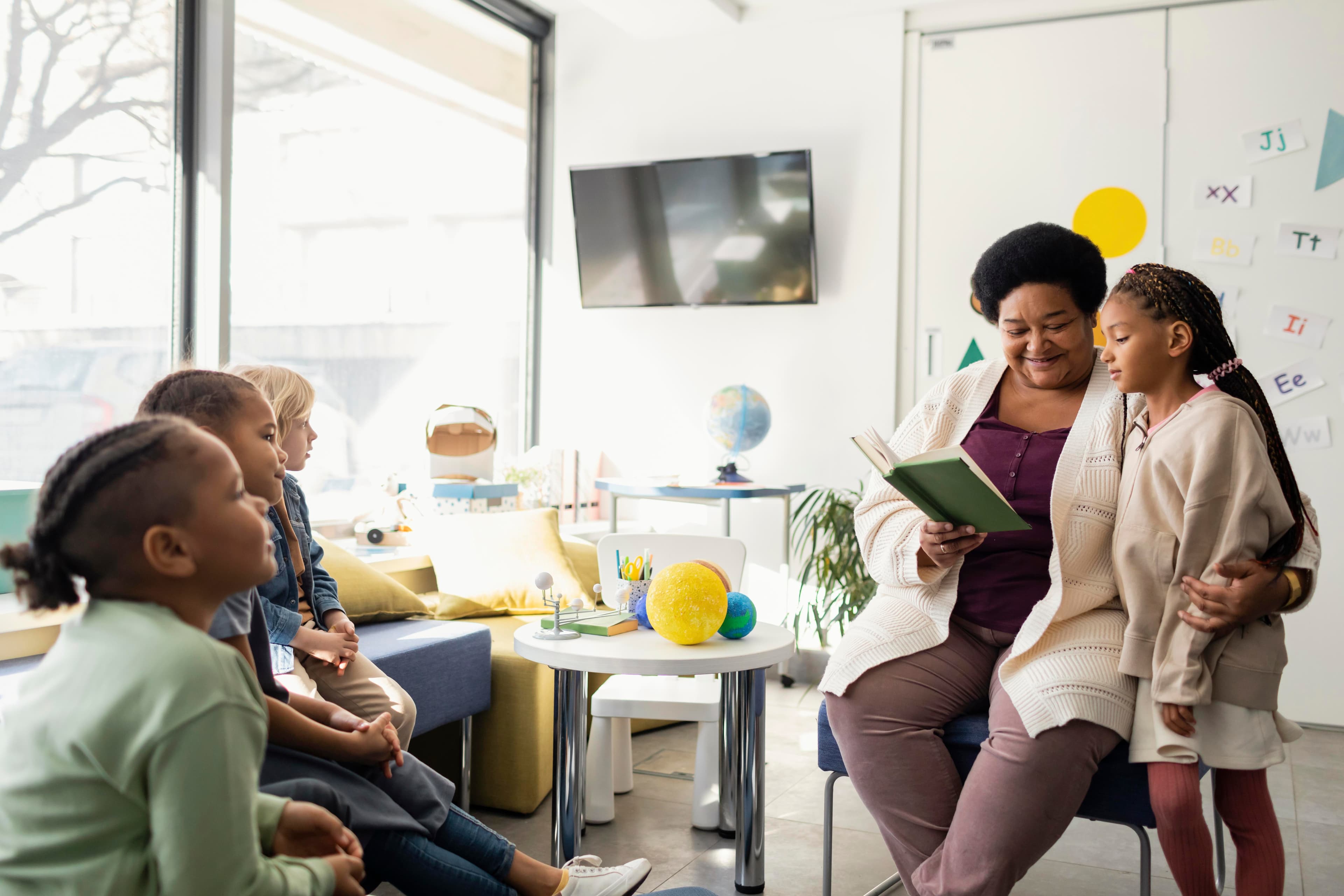 A teacher and her students learning together in a classroom
